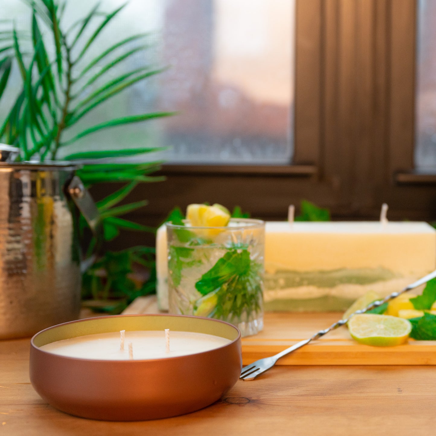 Mint Mojito with Pineapple with large soy wax scented candle and pillar scented candle with green concrete bottom on wooden table