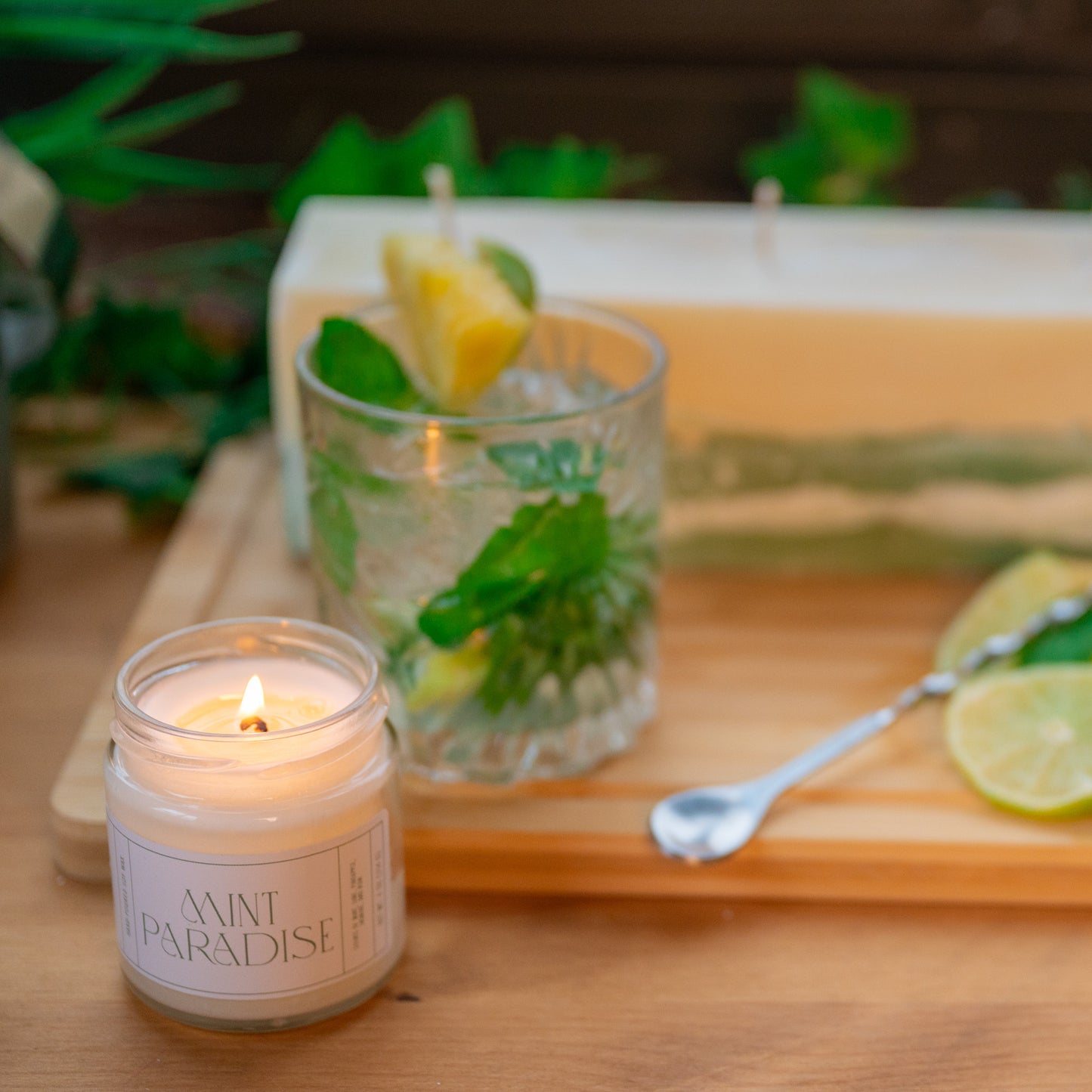 Mint Mojito with Pineapple with soy wax scented candle and pillar scented candle with green concrete bottom on wooden table