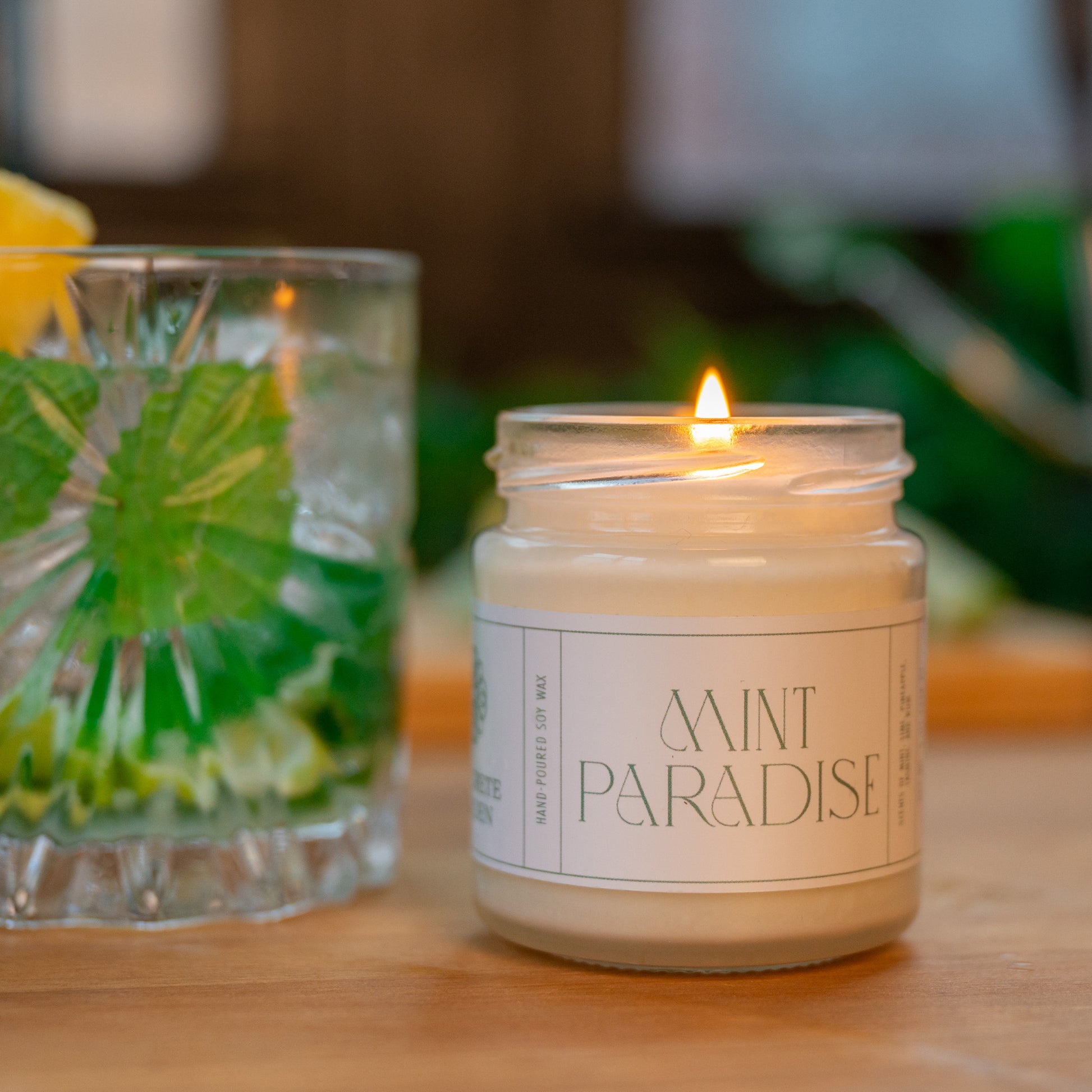 Mint Mojito with Pineapple with small soy wax scented candle lit on wooden table
